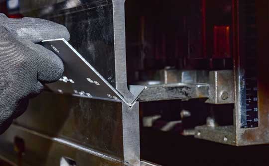 Bending sheet metal on a press brake in the SMF workshop in Wickford, Essex