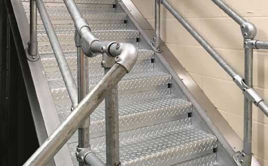 Staircase and clamplock handrail in stores area of London Underground depot in Upminster, Essex