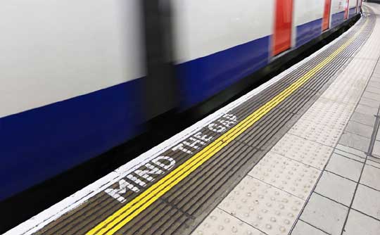 Platform edge warning signage at London Underground station